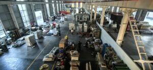 Inside view of a busy manufacturing workshop with machinery and workers