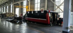 Laser cutting machine slicing through metal sheet